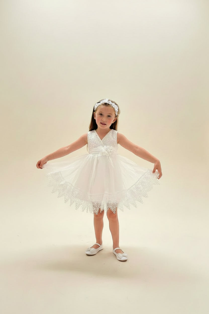 Young girl showcasing the full tulle skirt and wide scalloped lace trim of the Amelie Ivory Special Occasion Dress by Little Babybox.