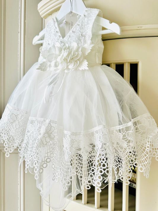Handmade ivory white lace christening dress with full A-line skirt featuring intricate lace and floral waist detail by Little Babybox.