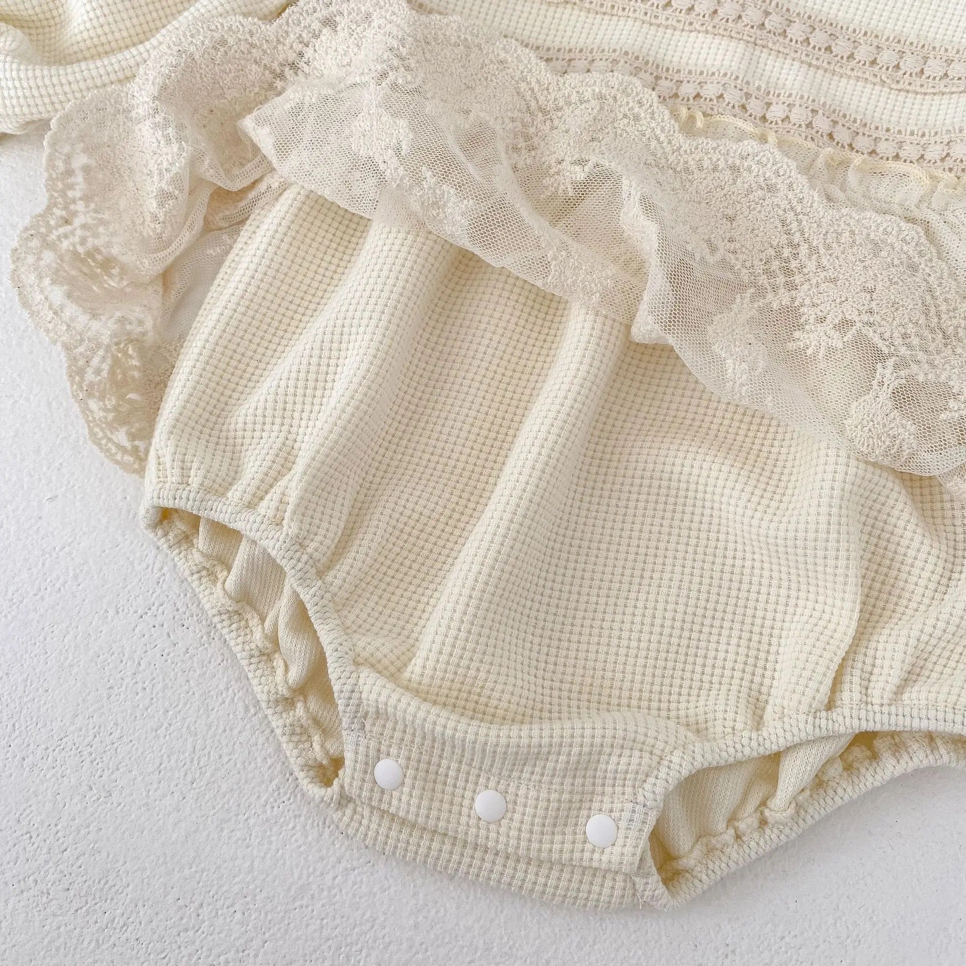 Oh Delilah Romper detail of waffle fabric and closed popper fastening.