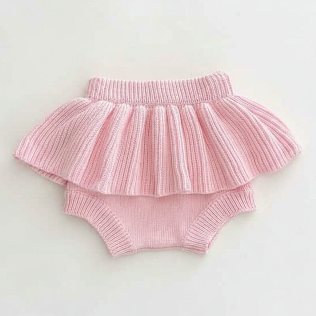 Close-up of Paloma pale pink ribbed knit bloomer shorts with double peplum ruffle frill - baby girl outfit by Little Babybox