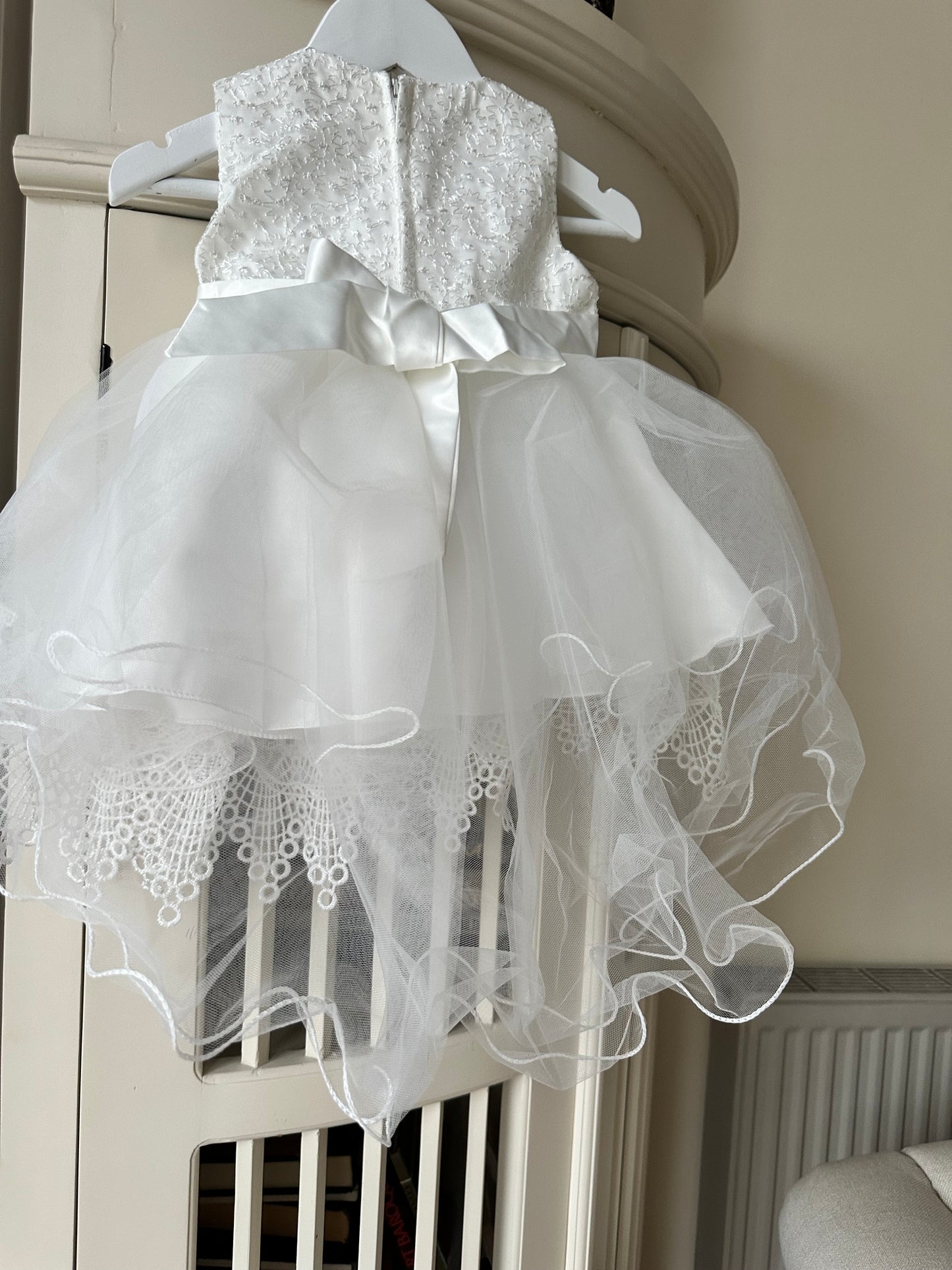 Back view of the handmade ivory white lace flower girl dress showing the neat zipper closure and elegant fabric finish by Little Babybox