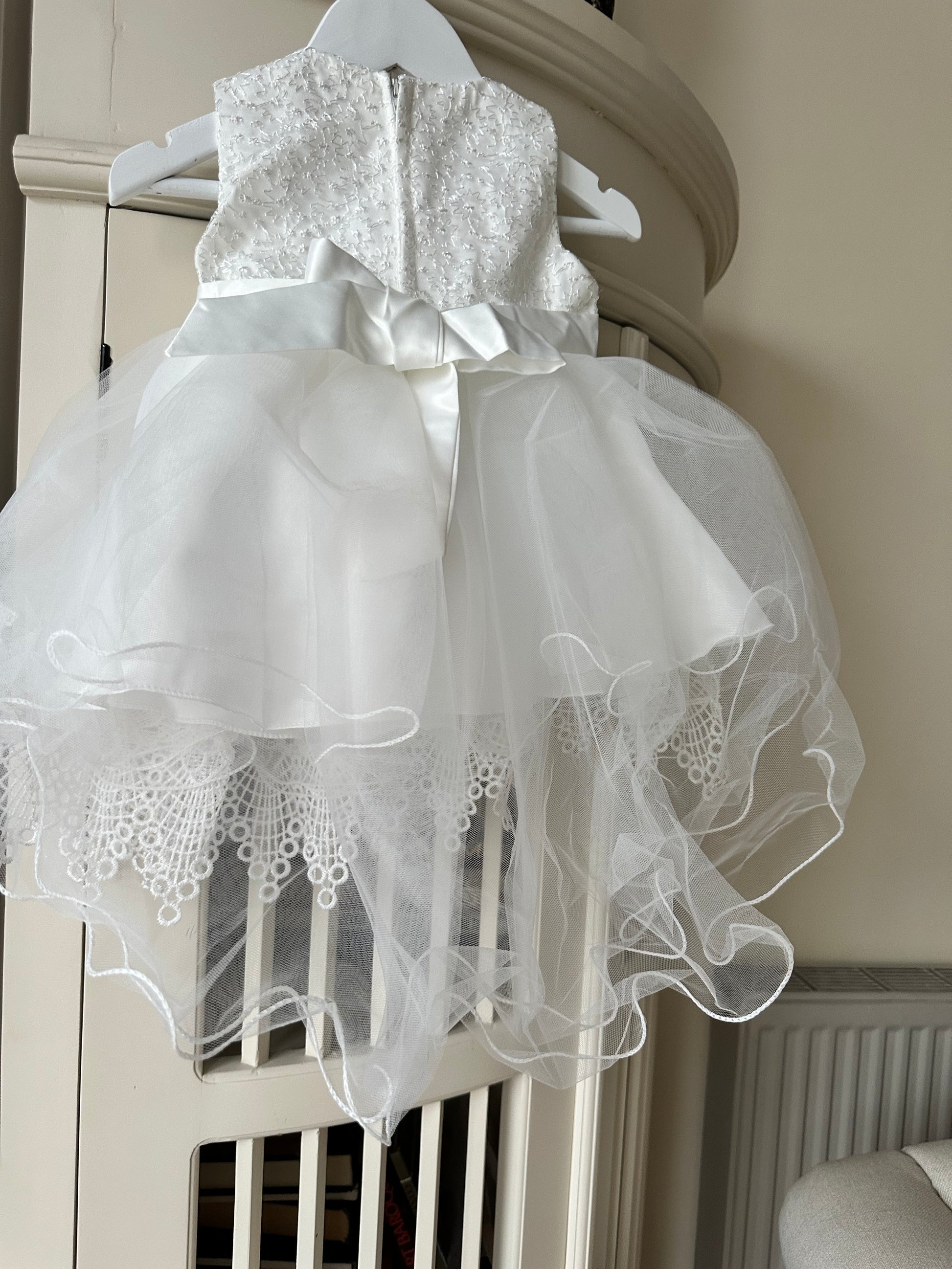 Back view of the handmade ivory white lace flower girl dress showing the neat zipper closure and elegant fabric finish by Little Babybox