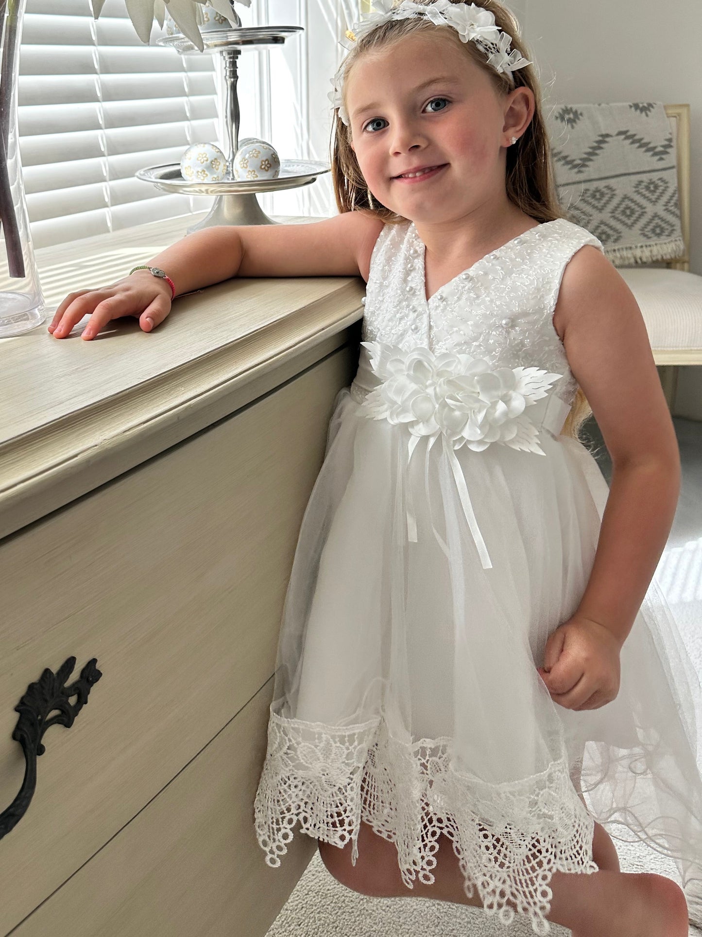Bridesmaid wearing the ivory white special occasion baby dress by Little Babybox