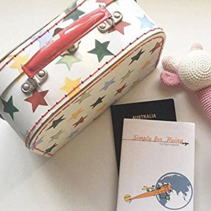 Children's travel bag with stars, a rattle toy, passport, and Simply for Flying Logbook - Little Babybox