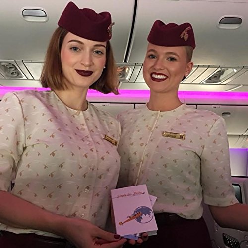 Two flight attendants in uniform on an airplane holding a Simply for Flying Logbook - Little Babybox
